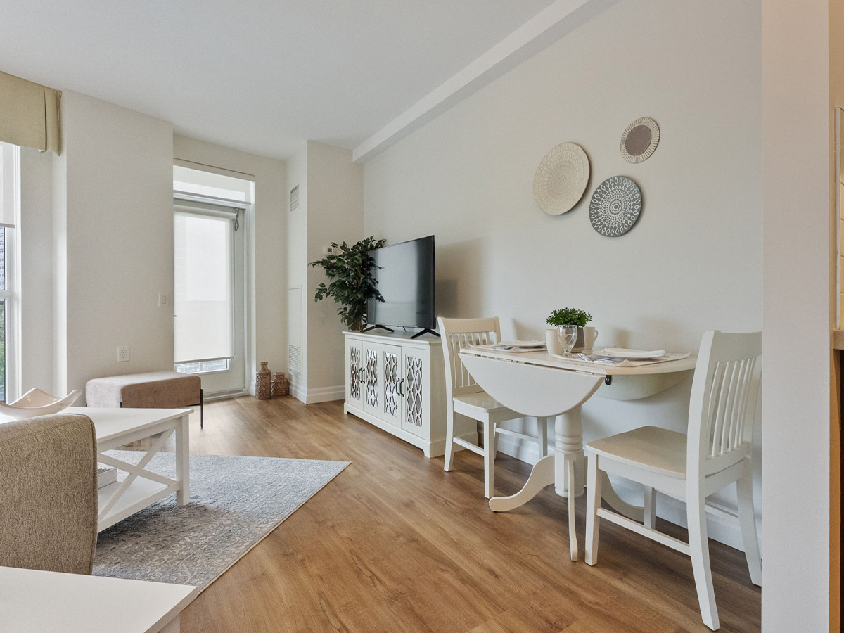 A clean living room at Walden Circle Retirement Home featuring a table and chairs arranged for comfort and socializing.