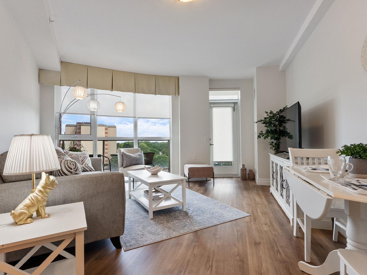 Bright and clean living room at Walden Circle Retirement Home, showcasing a couch, coffee table, and a sunny window.