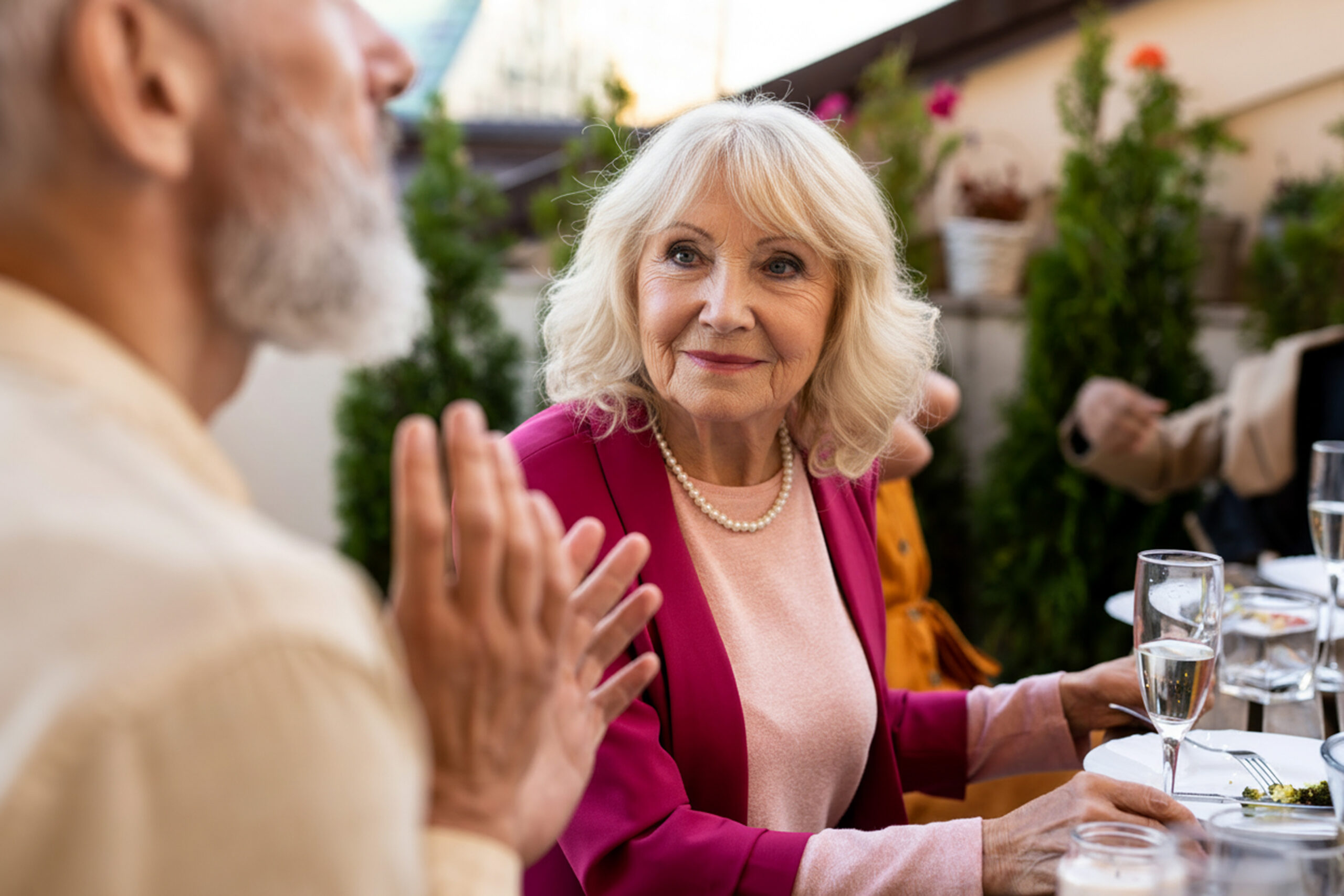 At Walden Circle Retirement Home, an older woman engages in conversation with a man at a dinner table.